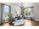 Cozy living room with hardwood floors, large windows, modern furnishings, and designer curtains at 7099 Cerney Cir, Castle Pines, CO 80108