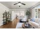 Cozy living room with hardwood floors, large windows, and views into the kitchen at 7099 Cerney Cir, Castle Pines, CO 80108