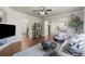 Open-concept living room showcasing hardwood floors and seamless flow into the kitchen and entry at 7099 Cerney Cir, Castle Pines, CO 80108