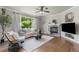Comfortable living room with stone fireplace and large windows providing ample natural light at 7099 Cerney Cir, Castle Pines, CO 80108