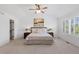 Bright main bedroom features a ceiling fan, plantation shutters, and carpet at 7099 Cerney Cir, Castle Pines, CO 80108