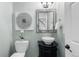 Stylish powder room featuring a vessel sink, decorative mirror, and elegant wall art at 7099 Cerney Cir, Castle Pines, CO 80108