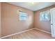 Bedroom with hardwood floors, neutral walls, and natural light from two windows at 1931 Dayton St, Aurora, CO 80010