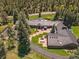 Aerial view of a large house with a metal roof and sprawling backyard at 32453 Upper Bear Creek Rd, Evergreen, CO 80439