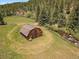Aerial view of charming barn on scenic property with surrounding natural landscape at 32453 Upper Bear Creek Rd, Evergreen, CO 80439