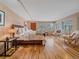 Spacious bedroom with wood floors, shuttered windows, and designer furniture at 32453 Upper Bear Creek Rd, Evergreen, CO 80439