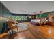 Large bedroom with a seating area, canopy bed, and bright windows at 32453 Upper Bear Creek Rd, Evergreen, CO 80439