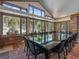 Dining room with large windows offering views of trees in a snow-covered landscape at 32453 Upper Bear Creek Rd, Evergreen, CO 80439