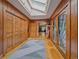 Hallway with wood paneled walls, wood floors, and a skylight at 32453 Upper Bear Creek Rd, Evergreen, CO 80439