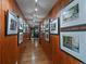 Wood paneled hallway decorated with many framed photos at 32453 Upper Bear Creek Rd, Evergreen, CO 80439