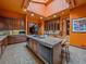 Custom kitchen with island cooktop, prep sink, and ample storage at 32453 Upper Bear Creek Rd, Evergreen, CO 80439