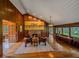Cozy living room with fireplace, hardwood floors, and nature views at 32453 Upper Bear Creek Rd, Evergreen, CO 80439