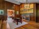 Inviting living room with fireplace, hardwood floors, and wood paneling at 32453 Upper Bear Creek Rd, Evergreen, CO 80439