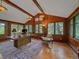 Bright home office with wood paneling and large windows offering natural light at 32453 Upper Bear Creek Rd, Evergreen, CO 80439