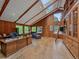 Well-lit office space featuring hardwood floors, a desk, and built-in wooden bookshelves at 32453 Upper Bear Creek Rd, Evergreen, CO 80439