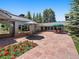 Stone patio with patio furniture and red flower bed at 32453 Upper Bear Creek Rd, Evergreen, CO 80439