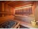 Relaxing sauna room with wooden benches and a traditional stone heater for ultimate comfort at 32453 Upper Bear Creek Rd, Evergreen, CO 80439