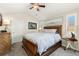 Spacious bedroom with vaulted ceilings, a ceiling fan, and bright windows with shutters at 8643 Gold Peak Dr # E, Highlands Ranch, CO 80130