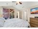 Bedroom features a ceiling fan, access to a porch, and access to an en-suite bathroom at 8643 Gold Peak Dr # E, Highlands Ranch, CO 80130