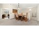 Open dining area with a rustic wood table set, adjacent to living room at 8643 Gold Peak Dr # E, Highlands Ranch, CO 80130