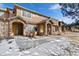 Attractive townhome exterior with stone accents, covered entryway, and a well-maintained walkway at 8643 Gold Peak Dr # E, Highlands Ranch, CO 80130