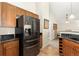 Kitchen featuring stainless steel refrigerator, granite countertops and wooden cabinets at 8643 Gold Peak Dr # E, Highlands Ranch, CO 80130