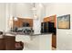 Well-lit kitchen boasts granite counters, stainless steel appliances, and wooden cabinetry at 8643 Gold Peak Dr # E, Highlands Ranch, CO 80130