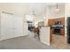 Inviting living room with an open floor plan and neutral tones flowing into the kitchen at 8643 Gold Peak Dr # E, Highlands Ranch, CO 80130