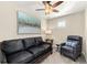 Cozy living room with a leather sofa, leather chair, throw pillow, and ceiling fan at 8643 Gold Peak Dr # E, Highlands Ranch, CO 80130