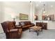 Open living space with leather seating, complemented by granite countertops and vaulted ceilings at 8643 Gold Peak Dr # E, Highlands Ranch, CO 80130