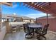 Outdoor patio with a pergola, ample seating, and manicured landscaping at 8643 Gold Peak Dr # E, Highlands Ranch, CO 80130