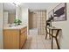 Bright bathroom showcasing tile floors, a vanity with drawers, tub, and shower combo at 2901 N Wyandot St # 19, Denver, CO 80211