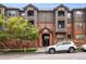 Building exterior with brick facade and a white SUV parked in front at 2901 N Wyandot St # 19, Denver, CO 80211