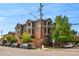 Multi-story apartment building featuring brick and grey exterior with mature trees at 2901 N Wyandot St # 19, Denver, CO 80211