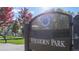 Community park entrance sign with fall foliage and playground in the background at 2901 N Wyandot St # 19, Denver, CO 80211