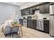 Modern kitchen features stainless steel appliances, dark cabinets, and quartz countertops at 2901 N Wyandot St # 19, Denver, CO 80211