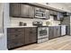 Modern kitchen features stainless steel appliances, dark cabinets and white countertops at 2901 N Wyandot St # 19, Denver, CO 80211