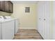 Bright laundry room featuring a washer, dryer, storage cabinets, and a spacious closet at 2901 N Wyandot St # 19, Denver, CO 80211