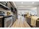 Open concept living room and kitchen features stainless steel appliances and natural lighting at 2901 N Wyandot St # 19, Denver, CO 80211