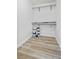 Walk-in closet with shelving, rod, and storage for paint and home essentials at 2901 N Wyandot St # 19, Denver, CO 80211