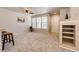 Bright living space featuring large windows, neutral decor and built-in shelving at 6745 S Winnipeg Cir # 103, Aurora, CO 80016