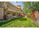 Two-story home featuring a spacious deck, a lush green lawn, and mature trees for backyard enjoyment at 12663 S Silver Creek Ct, Parker, CO 80134