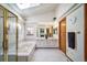Bright, spacious bathroom with dual sinks, vanity, soaking tub, a skylight, and a gold-trimmed glass shower at 12663 S Silver Creek Ct, Parker, CO 80134