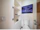 Cozy, clean bathroom featuring built in shelving with decor, a support bar, and modern fixtures at 12663 S Silver Creek Ct, Parker, CO 80134