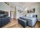 Inviting bedroom with hard wood floors, accent wall art, soft lighting, and stylish furnishings at 12663 S Silver Creek Ct, Parker, CO 80134