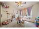 bedroom with ceiling fan, large window, and space for play and learning at 12663 S Silver Creek Ct, Parker, CO 80134