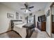 Bedroom features a ceiling fan, carpet, black framed bed and updated window coverings at 12663 S Silver Creek Ct, Parker, CO 80134