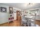 Dining room featuring a white table with chairs, hutch, laminate floors and modern lighting at 12663 S Silver Creek Ct, Parker, CO 80134