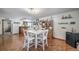 Dining area with wood-look flooring, a white table with chairs, and a hutch for storage at 12663 S Silver Creek Ct, Parker, CO 80134