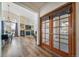 Open foyer featuring view into living space with stone fireplace and dining area at 12663 S Silver Creek Ct, Parker, CO 80134
